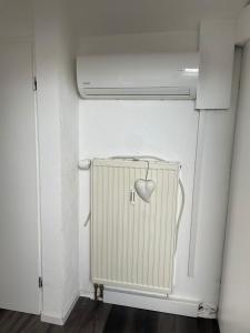 a white radiator with a heart on it in a room at Central Ferienwohnung in Bad Saulgau