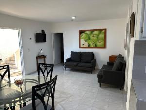 a living room with a glass table and a couch at Apto comodo, muy cerca de playa 101 in Mazatlán