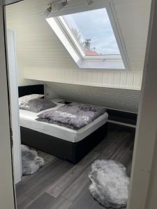 a bedroom with two beds and a skylight at Central Ferienwohnung in Bad Saulgau