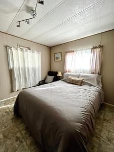 a bedroom with a large bed and a window at Roberts Roost Resort in Quesnel