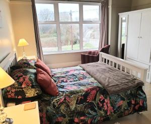a bedroom with a bed and a window at Beach House, Llanddulas near Colwyn Bay in Llanddulas