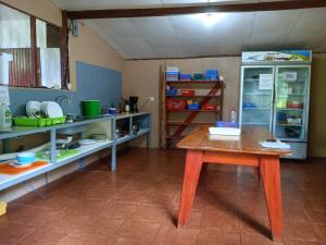 a kitchen with a table and a refrigerator at Jacobin Hostel & Cabins in Drake +85 photos