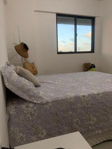 a bedroom with a bed with a window at Apartamento a Beira-Mar - Praia do Francês in Marechal Deodoro