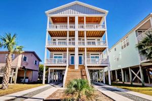 a large house with stairs leading up to it at Blue Oasis in Carolina Beach