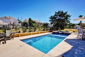a swimming pool in a yard with a fence at Blue Oasis in Carolina Beach