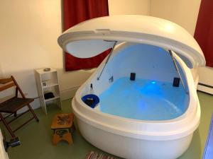 a bath tub with a pool of water in a room at Base Camp Anchorage Hostel in Anchorage