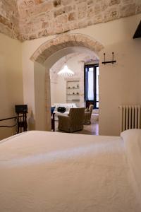 a bedroom with a bed and a living room at CASA RITELLA in Castellana Grotte