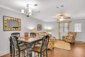 a dining room and living room with a table and chairs at Courtyard Villa B-2 in Saint Simons Island