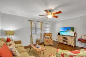 a living room with a couch and a flat screen tv at Courtyard Villa B-2 in Saint Simons Island