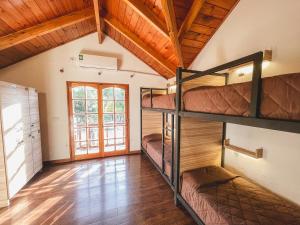 a room with bunk beds in a house at Hostel Falucho in Capilla del Monte