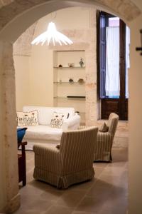 a living room with couches and chairs and a chandelier at CASA RITELLA in Castellana Grotte