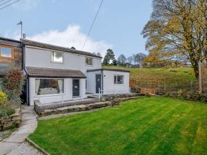 a white house with a lawn in front of it at 2 Bed in Skipton 83775 in Barnoldswick