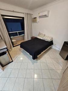 1 dormitorio con cama y ventana grande en DP101 - AP Gigante, 2 Suítes, 2 Quartos, Diferenciado, 250m2, Próximo a Praia Central en Balneário Camboriú