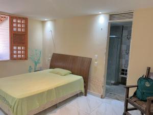 a bedroom with a bed and a walk in shower at Casa Tío Luiz in Aquiraz