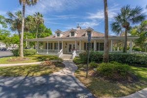 a house with palm trees in front of it at Ocean Walk E-5 in Saint Simons Island