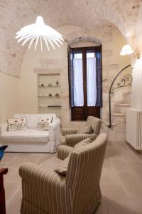 a living room with two couches and two chairs at CASA RITELLA in Castellana Grotte