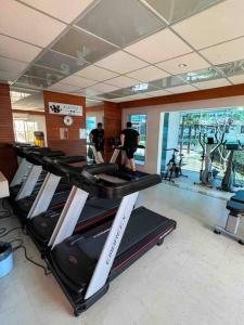 a gym with a row of treadmills in a room at Apartamento com vista para o mar in Vitória