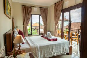 a bedroom with a bed and a large window at Rama House in Ubud +59 photos