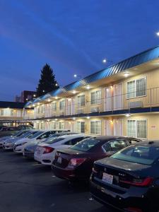 a row of cars parked in front of a building at Columbus Motor Inn in Seattle