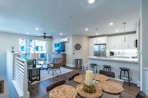 a kitchen and living room with a table and chairs at Pristine and Luxe, Steps to Mission Beach and Bay! in San Diego