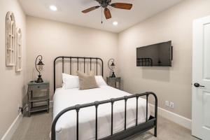 a bedroom with a bed and a ceiling fan at Pristine and Luxe, Steps to Mission Beach and Bay! in San Diego