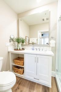 a white bathroom with a sink and a toilet at Pristine and Luxe, Steps to Mission Beach and Bay! in San Diego