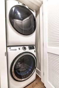 a microwave and a washer and dryer in a room at Pristine and Luxe, Steps to Mission Beach and Bay! in San Diego