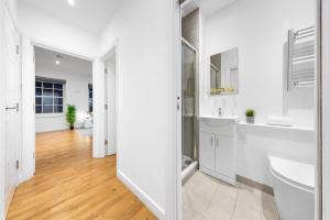 a white bathroom with two sinks and a mirror at Modern One Bed Apartment - Sleeps 3 - Near Heathrow, Windsor Castle, Thorpe Park - Staines London TW18 in Staines upon Thames