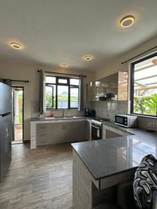 a kitchen with stainless steel appliances and a counter top at 2 bedroom multi-family home in Flic-en-Flac