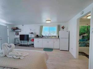 a kitchen with a bed with two swans on it at Sun Cabin #2 Pahrump in Pahrump