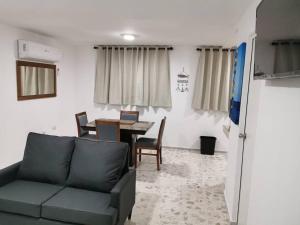 a living room with a couch and a table at Excelente apto muy cerca de la playa 202 in Mazatlán