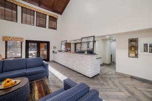 a lobby with blue couches and a bar at Quality Inn & Suites Goodyear - Phoenix West in Goodyear