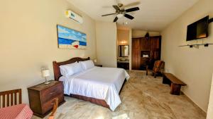 a bedroom with a bed and a ceiling fan at Myoli Wellness & Happiness BnB in Playa del Carmen