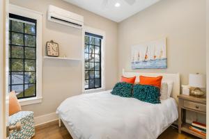 a bedroom with a bed and two windows at Colby's Castle in Charleston