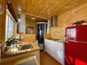 a kitchen with a red refrigerator and white cabinets at Sun Tiny House A Pahrump in Pahrump