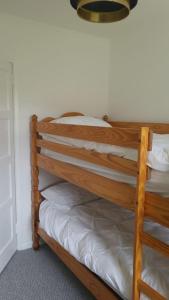 a wooden bunk bed in a room at Gortree at Castlerock in Castlerock