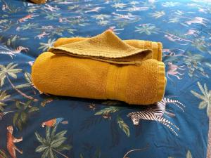 a yellow bag sitting on top of a bed at City Of Chester Award Winning Cottage -Pixie Terrace Chester in Chester