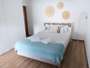 a bedroom with a large bed with towels on it at Hostel Retiro do Gerês in Geres