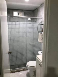 a small bathroom with a toilet and a shower at 302 Excelente apto muy Cerca de Playa in Mazatlán