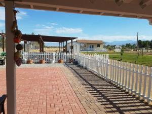 a white picket fence next to a house at Sun Tiny House B Pahrump in Pahrump
