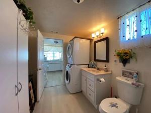 a bathroom with a refrigerator and a toilet and a sink at Sun Tiny House B Pahrump in Pahrump