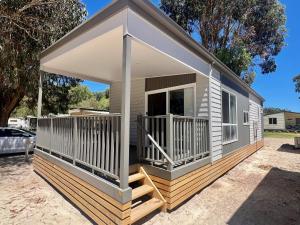 a small house with a porch and a deck at Esperance Pink Lake Tourist Park in Esperance