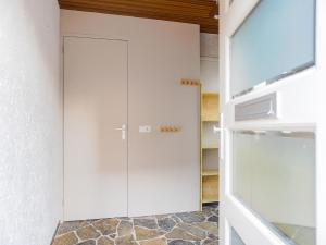 a white closet with a door in a kitchen at Vacation home 450 m from the beach in Katwijk aan Zee