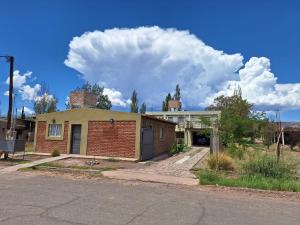 una vecchia casa di mattoni sul lato di una strada di Mercedario Aparts a Barreal