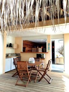 a wooden table and chairs in a kitchen at Studio Ti Kaye avec Jacuzzi in Les Trois-Îlets