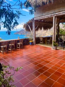 a resort patio with a view of the ocean at Hostal Casa Horizonte in Taganga