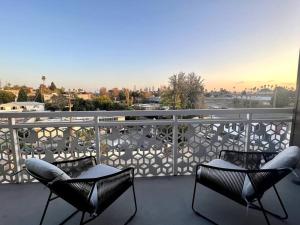 a balcony with chairs and a view of a city at NEW One Bedroom Penthouse, Silver Lake + Parking! in Los Angeles