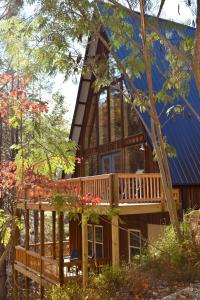 a large wooden house with a large deck at Cabin Coco - June sale dates! Luxe A Frame with projector screen, arcade and swim spa in Sevierville
