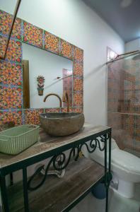 a bathroom with a stone sink and a mirror at El ocaso in Quimbaya
