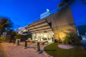 um edifício com bancos à sua frente à noite em Vip Praia Hotel em Natal